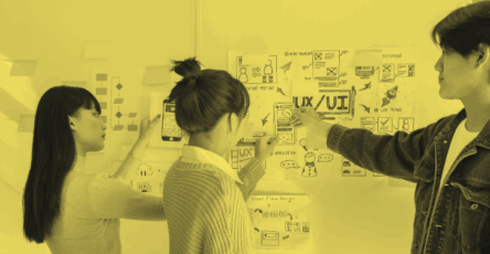 Designers discussing how to find UX designer jobs.