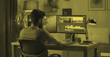 A freelance video editor is editing footage on his computer.