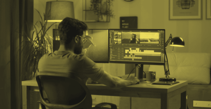 A freelance video editor is editing footage on his computer.