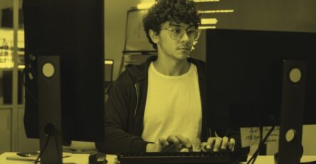 A web app developer working at their desk.