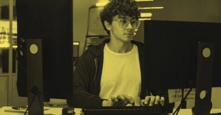 A web app developer working at their desk.